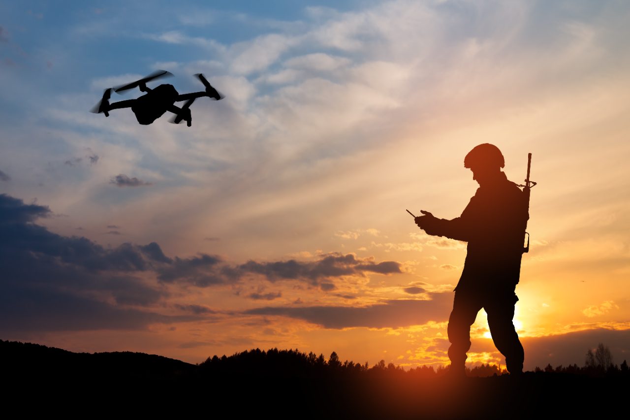 Soldier operating a reconnaissance drone at sunset